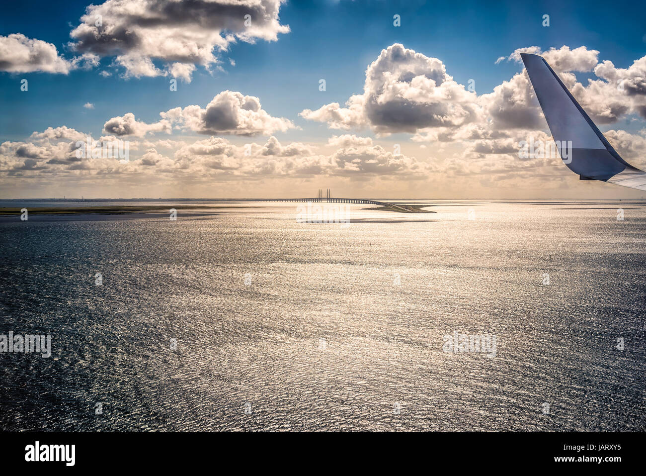 Wing of an airplane flying above the clouds Stock Photo - Alamy