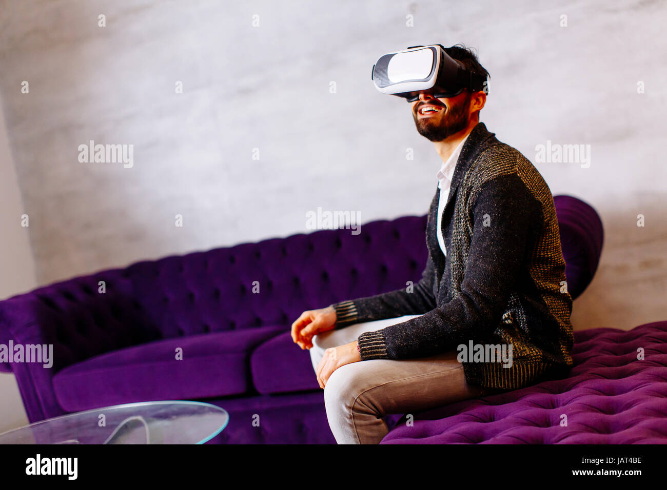 Closeup of bearded young man wearing virtual reality goggles in modern ...
