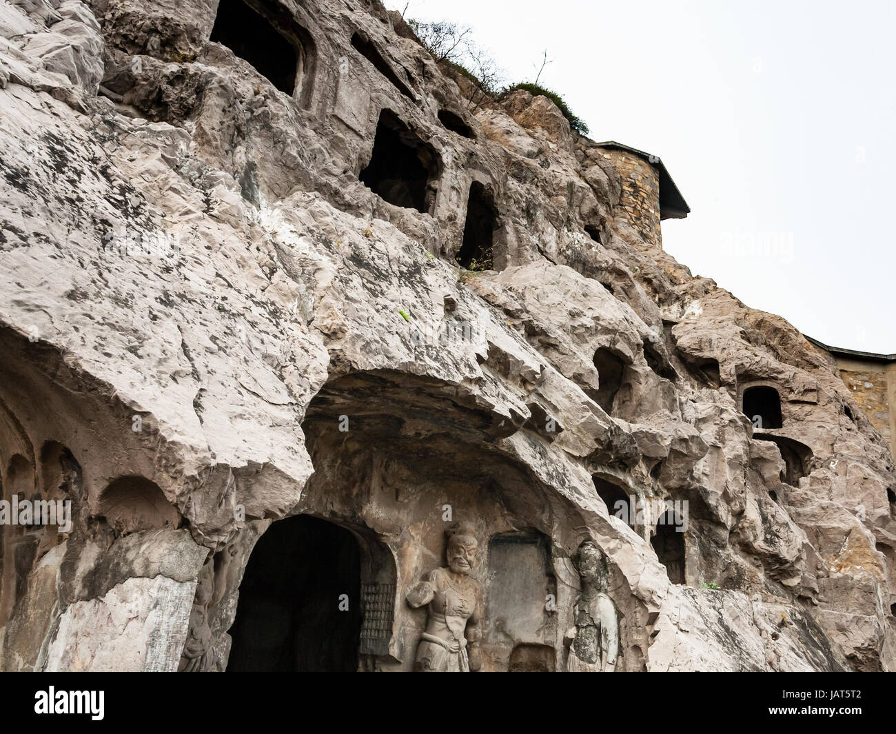 LUOYANG, CHINA - MARCH 20, 2017: carved slope of caves in West Hill of Chinese Buddhist monument Longmen Grottoes. The complex was inscribed upon the  Stock Photo