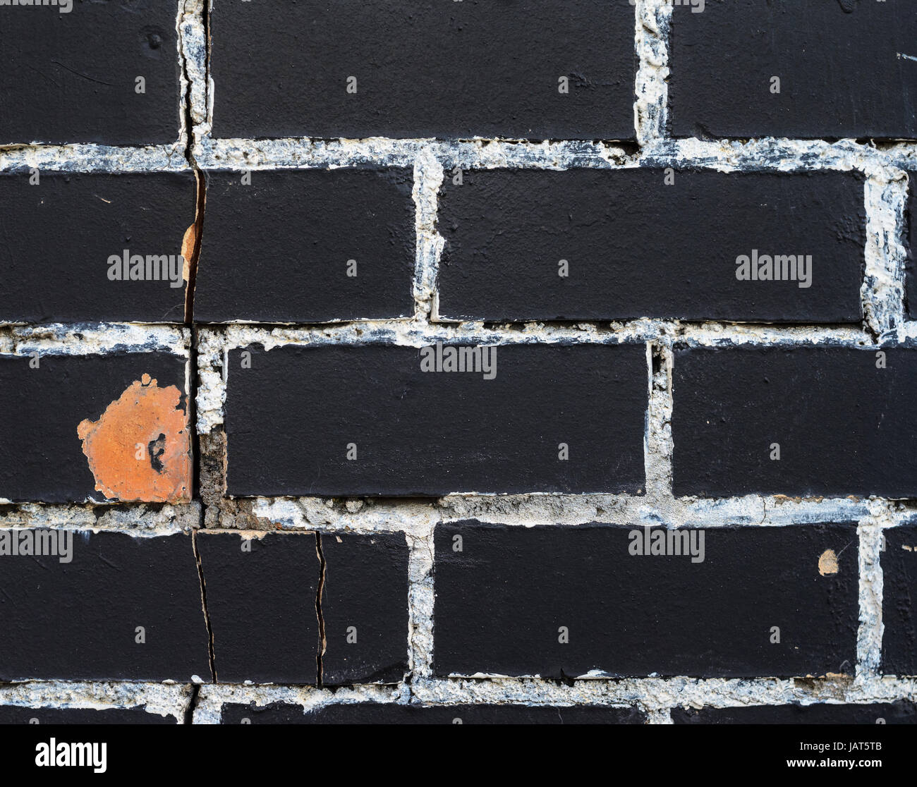 Rough brick wall texture painted in black with painting seams in white