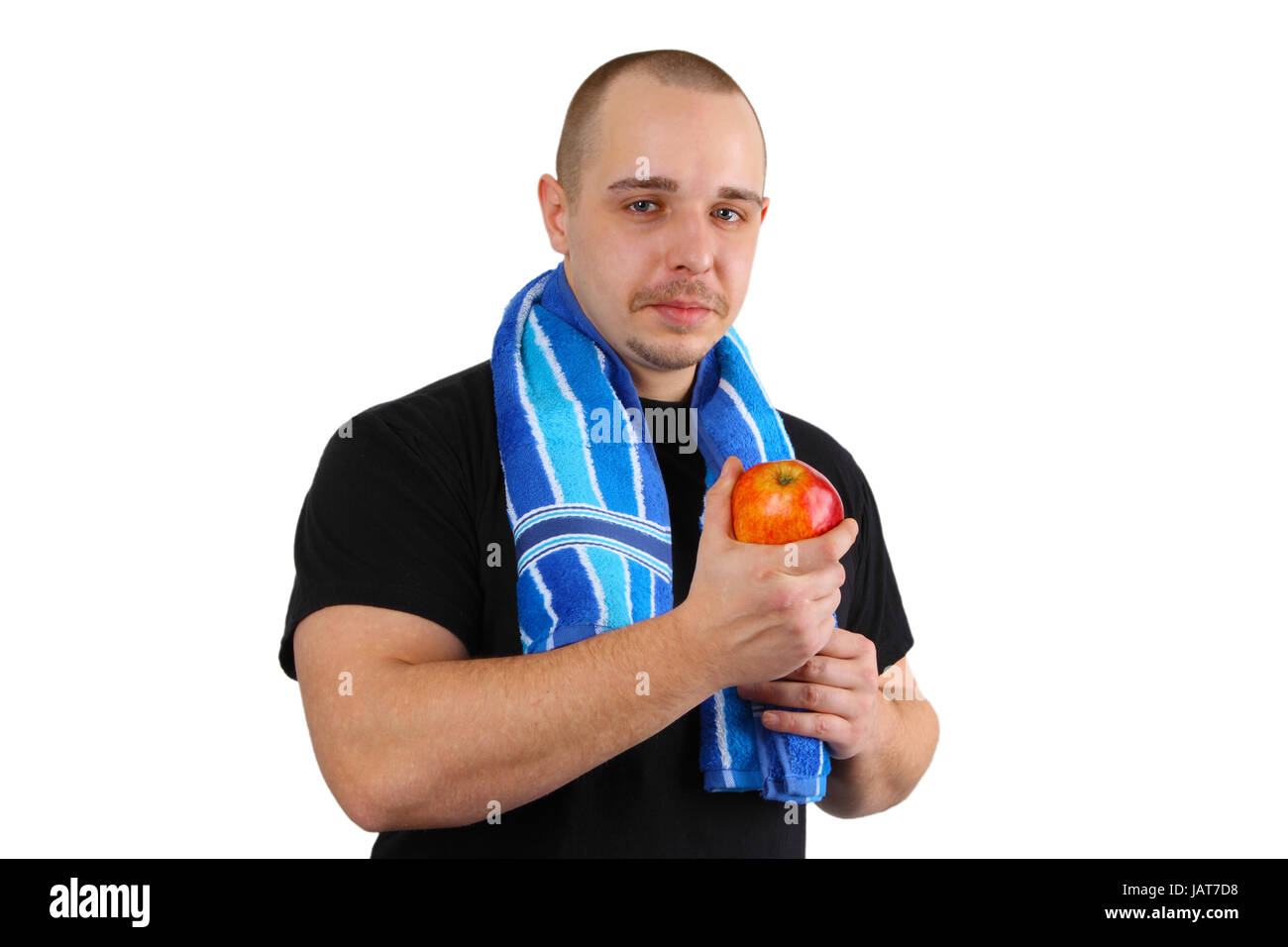Young sportsman man holds red apple on white background Stock Photo - Alamy
