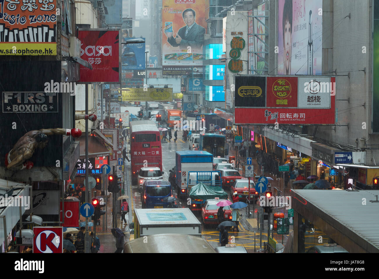 Rain, signs and traffic congestion on Sai Yeung Choi Street, Mong Kok, Kowloon, Hong Kong, China Stock Photo