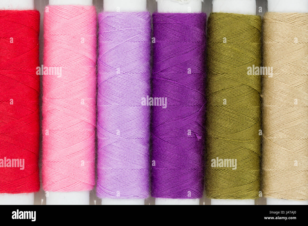 Colorful yarns spool isolated on white Stock Photo - Alamy