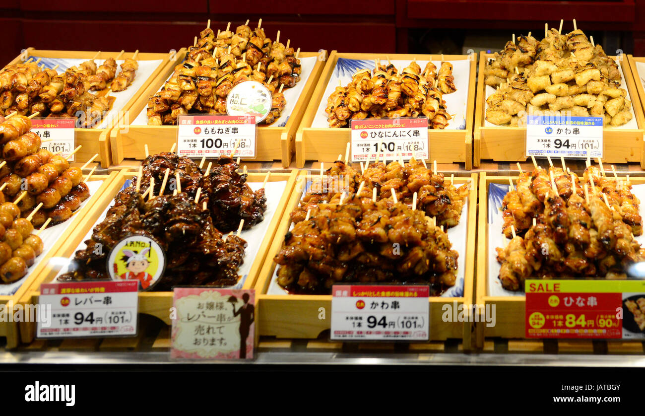 Yakitori and other Japanese grilled meat on skewers on display in a