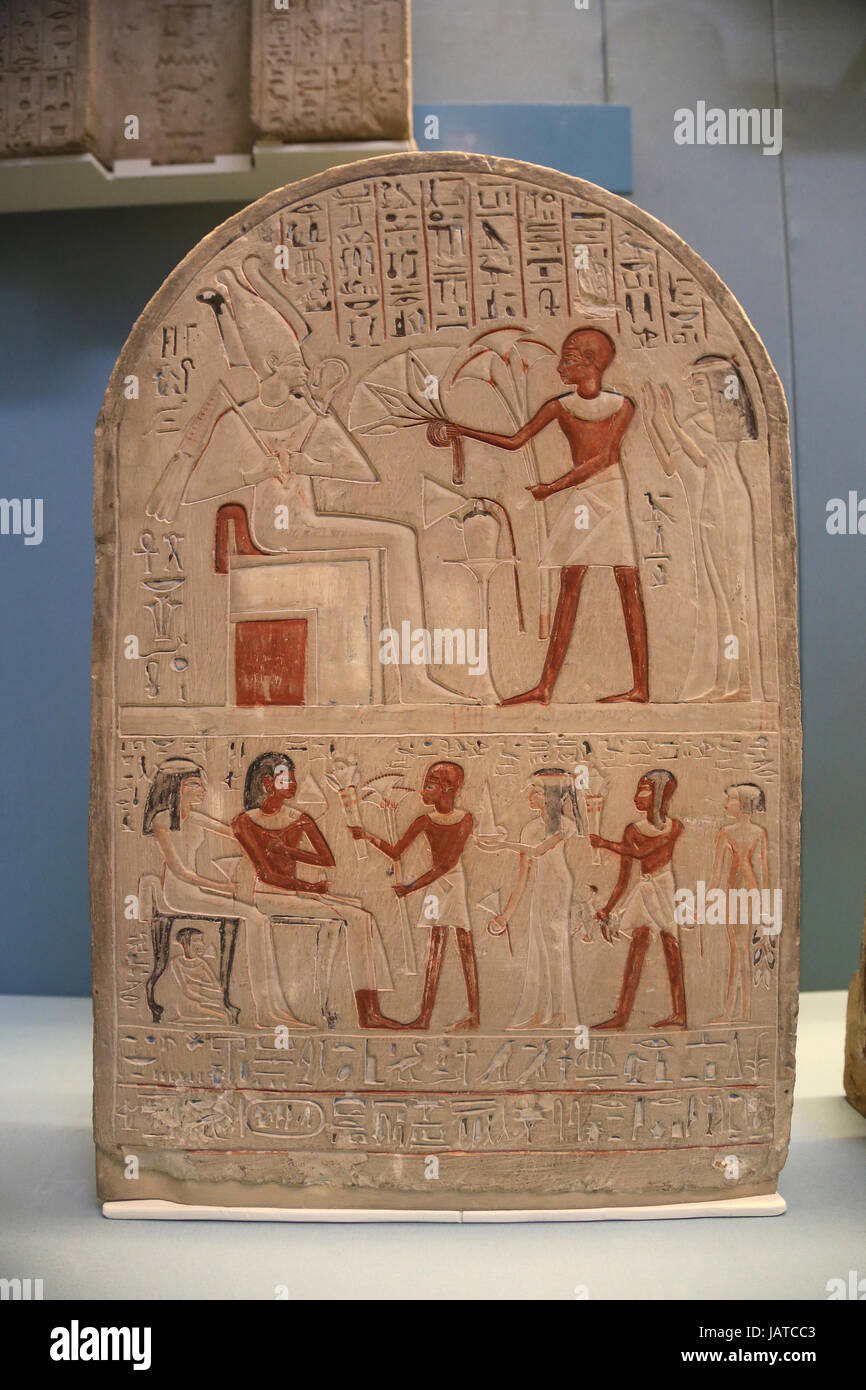 Painted limestone stela of Bakkay. 18th Dynasty,1390-1352 BC. Deceased offers flowers to Osiris. Below four members family with a couple. British Muse Stock Photo