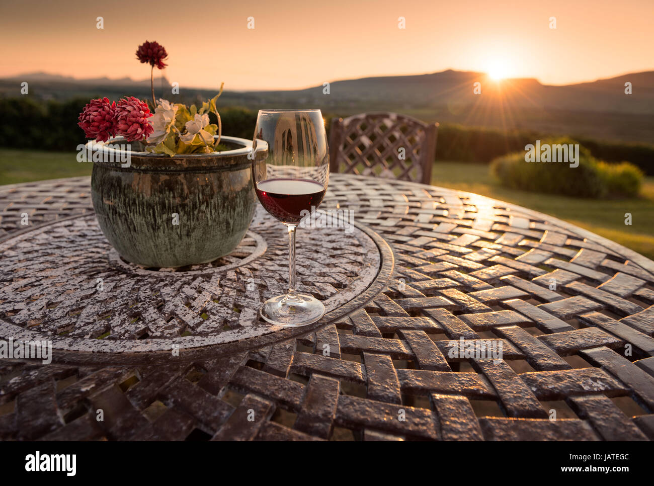 Dingle, Ireland - Relaxing glass of red wine catching the sunset light Stock Photo