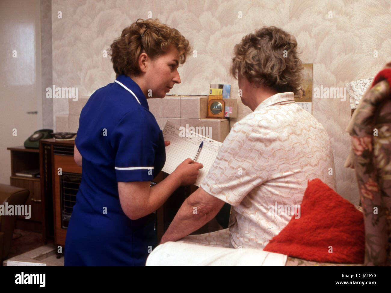 home help carers district nurse on a home visit to elderly woman in sheltered accommodation Stock Photo