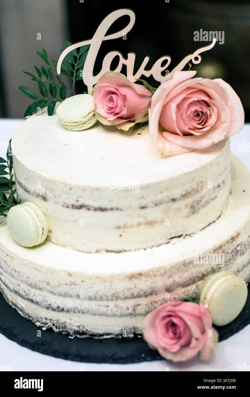 Beautiful Wedding Cake With Cream With Text Love On Top And Pink Flowers Roses Stock Photo Alamy