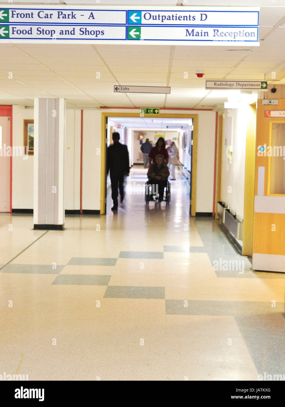 NHS Hospital IN the UK, Signage with busy hospital corridors looking empty and showing onto the ward and outpatient departments Stock Photo