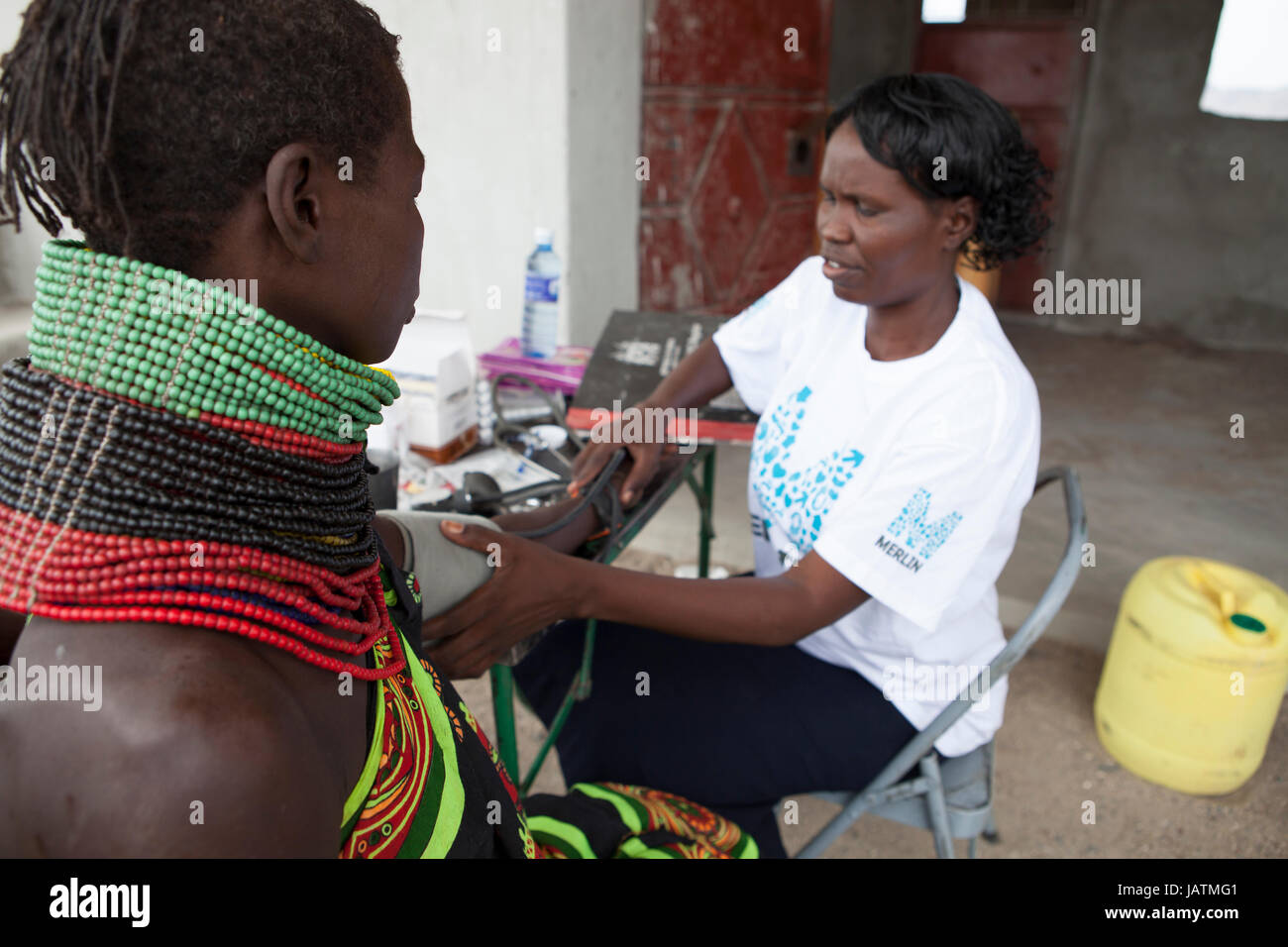 A community health nurse takes a woman's blood pressure, rural Kenya, Africa Stock Photo
