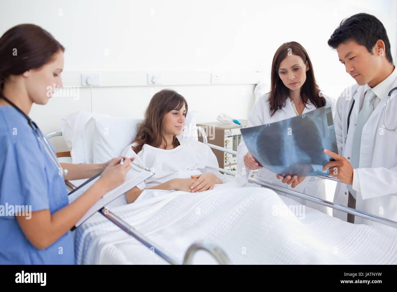 Doctors showing an xray scan to a patient Stock Photo Alamy