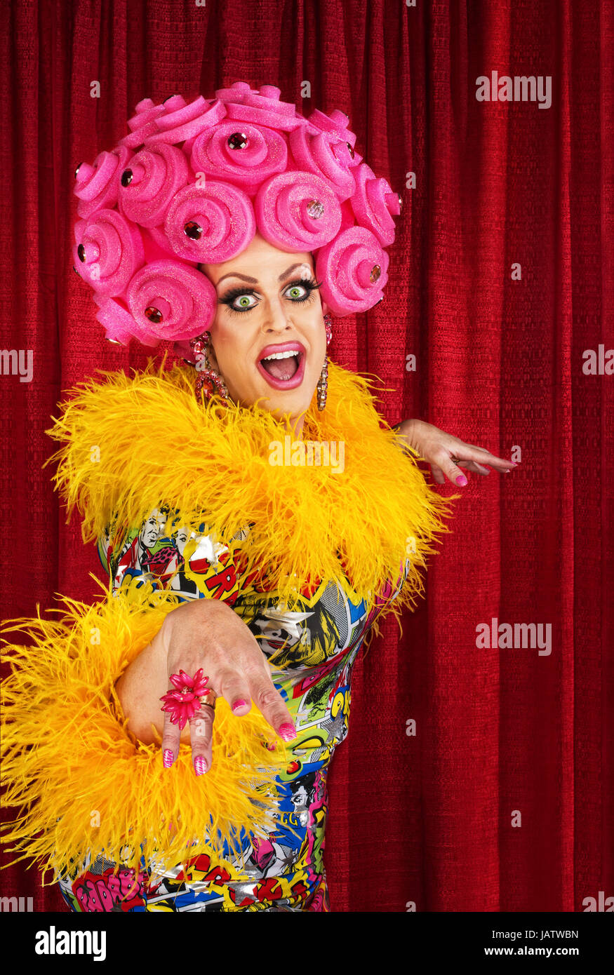 Stylish drag queen in wig holding makeup brush near face isolated on  grey,stock image Stock Photo - Alamy