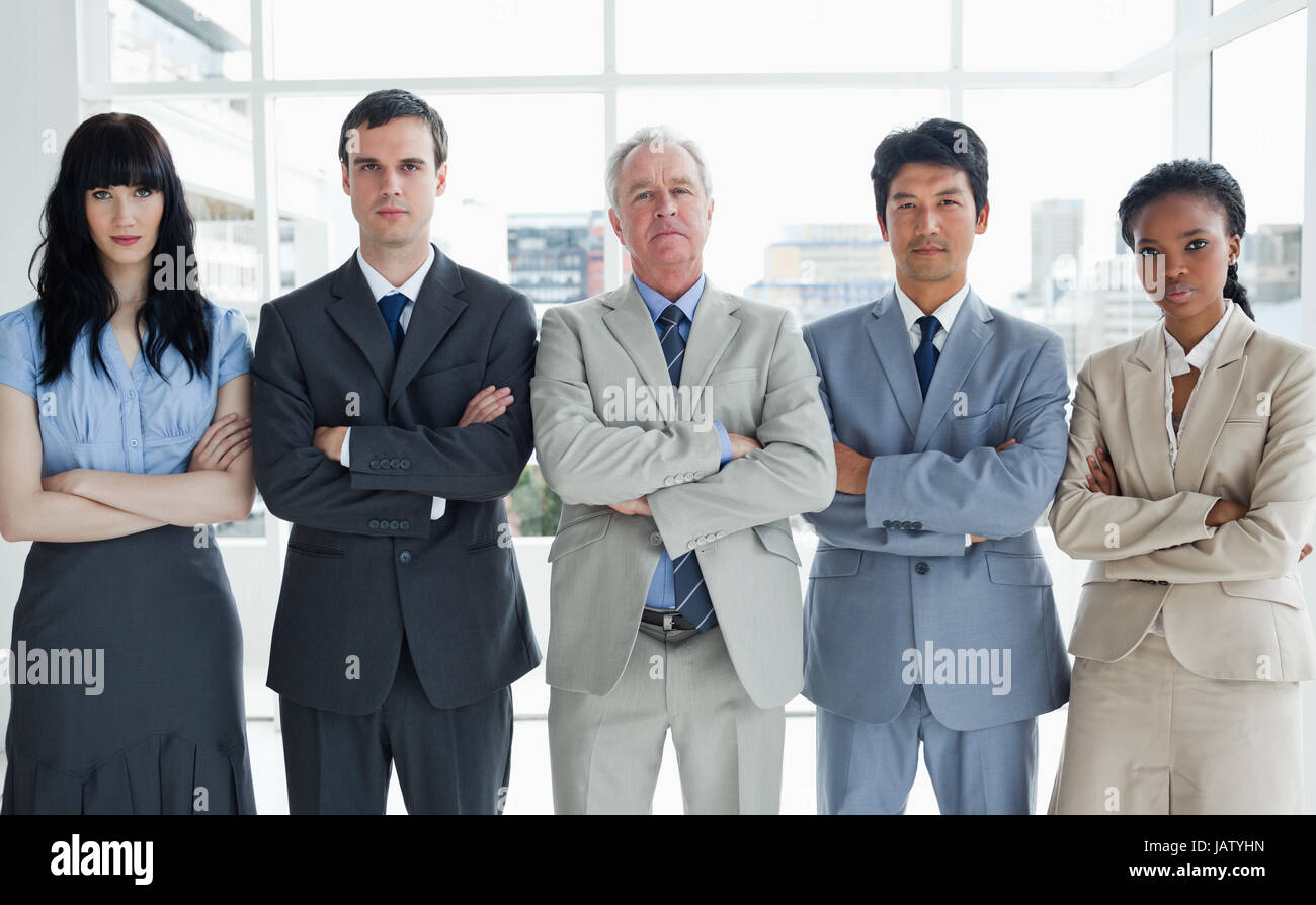 Five serious business people crossing their arms in a bright room Stock ...