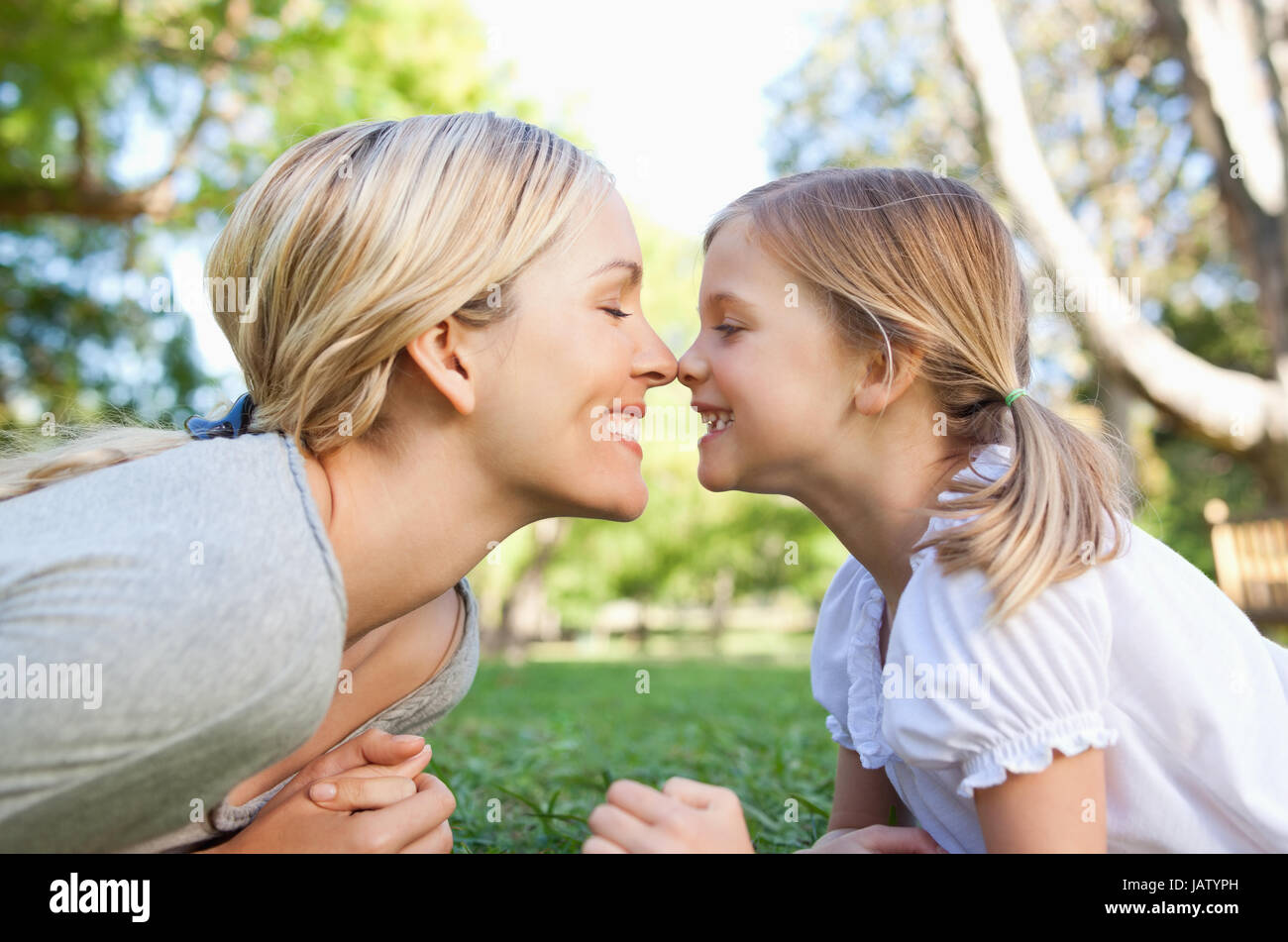 A mother and daughter rub noses together Stock Photo Alamy