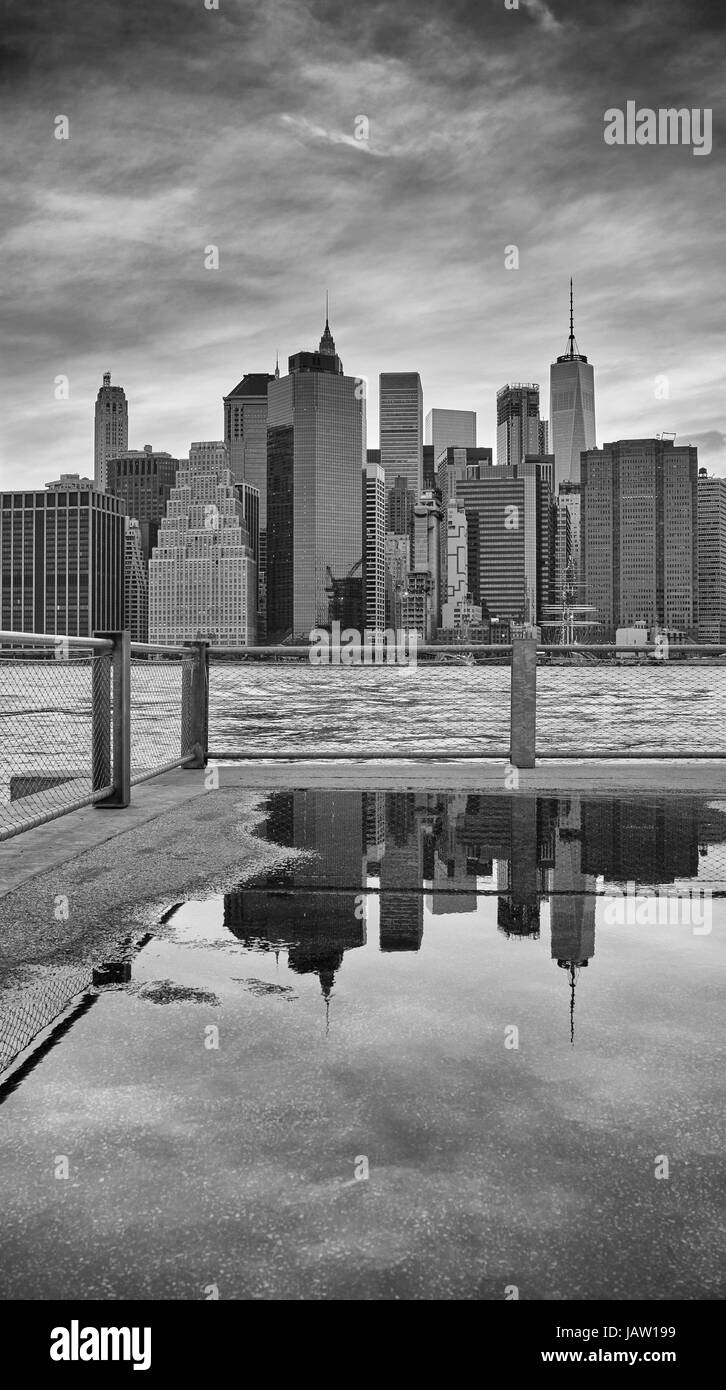 Manhattan skyline reflected in a puddle, Brooklyn Borough, New York City, USA. Stock Photo