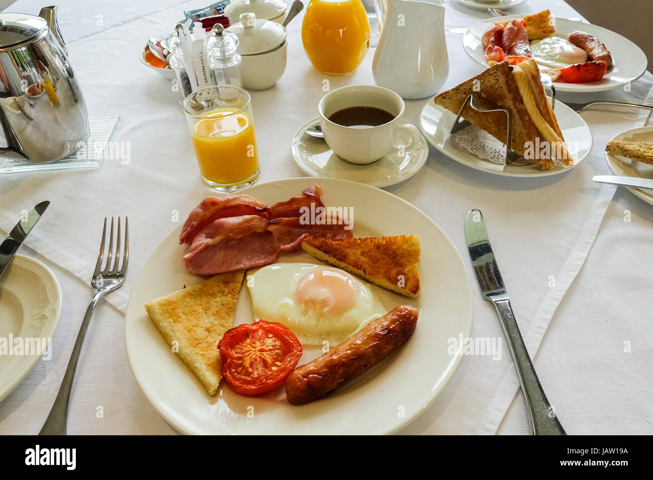Ulster fry, full breakfast including fried egg, bacon rashers, tomato