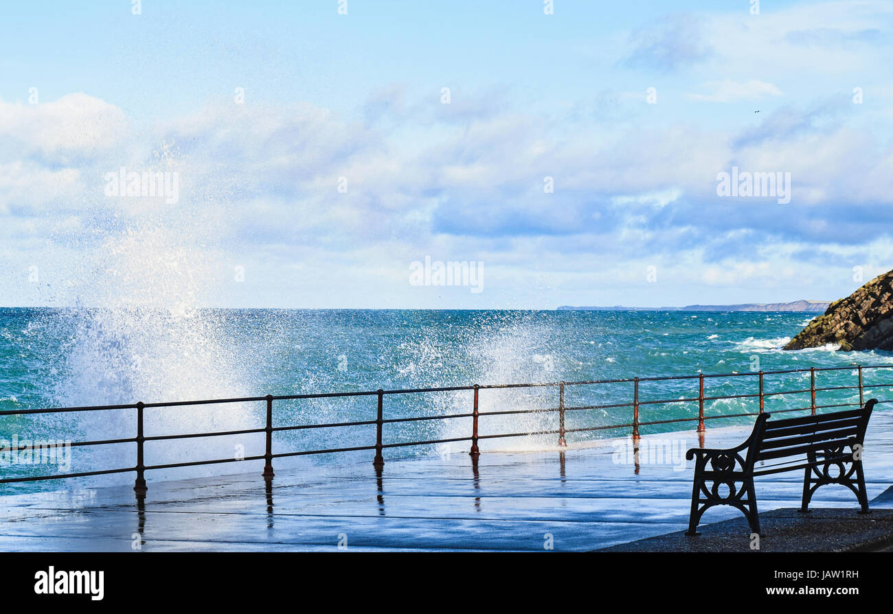 Seat facing stormy sea at Peel seafront Stock Photo