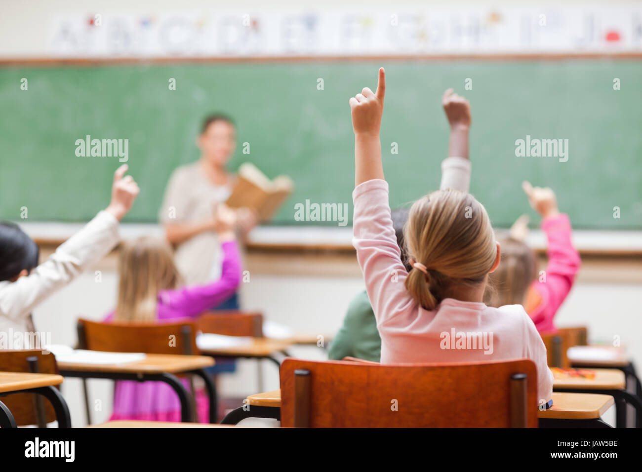 Girl rising hand school hi-res stock photography and images - Alamy