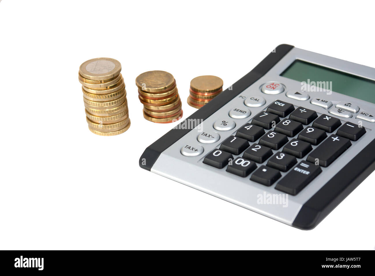 Calculator and coin stacks in background Stock Photo Alamy