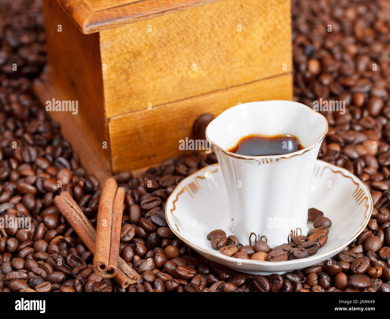 small cup of coffee and roasted coffee beans with retro wood manual