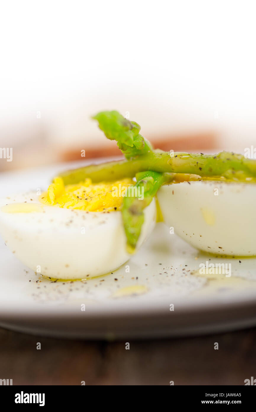 boiled fresh green asparagus and eggs with extra virgin olive oil Stock ...