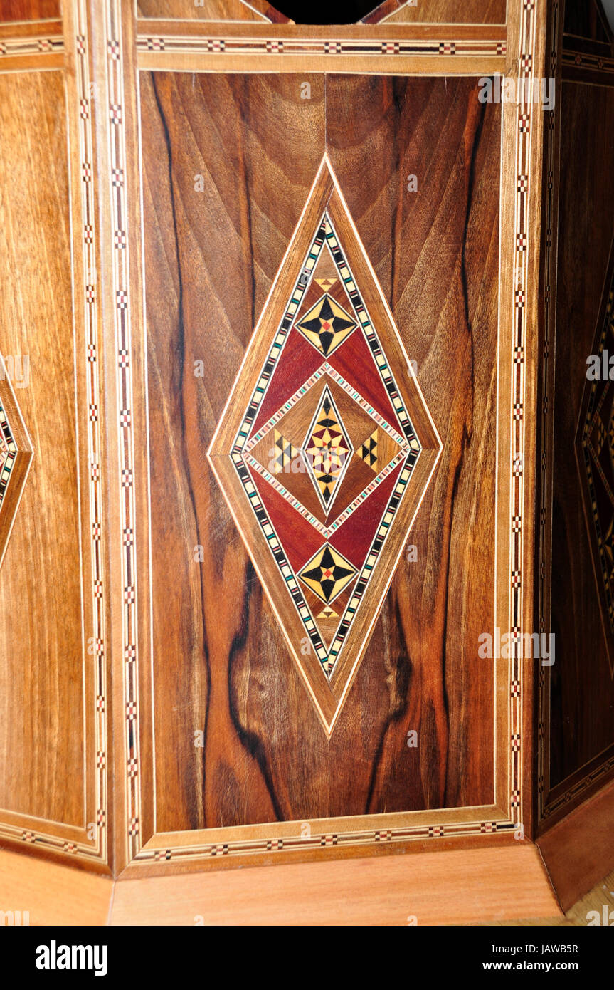 An intricately constructed wood inlay panel using multiple coloured