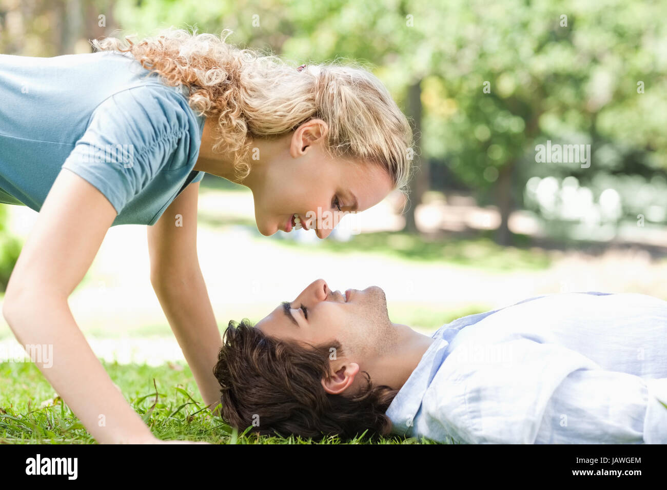 Side view of a happy couple on the lawn Stock Photo - Alamy