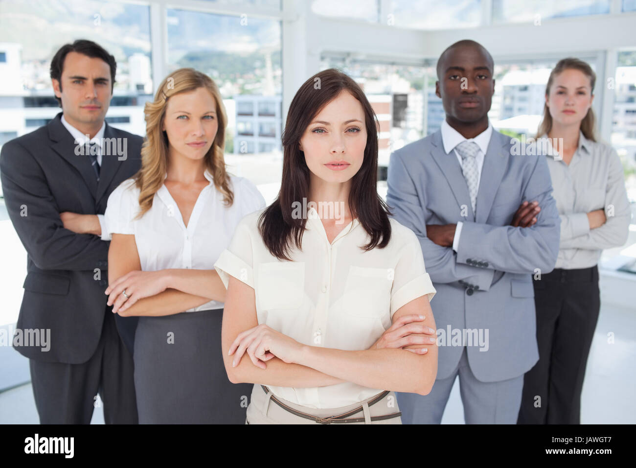 Five serious colleagues standing near each other Stock Photo - Alamy