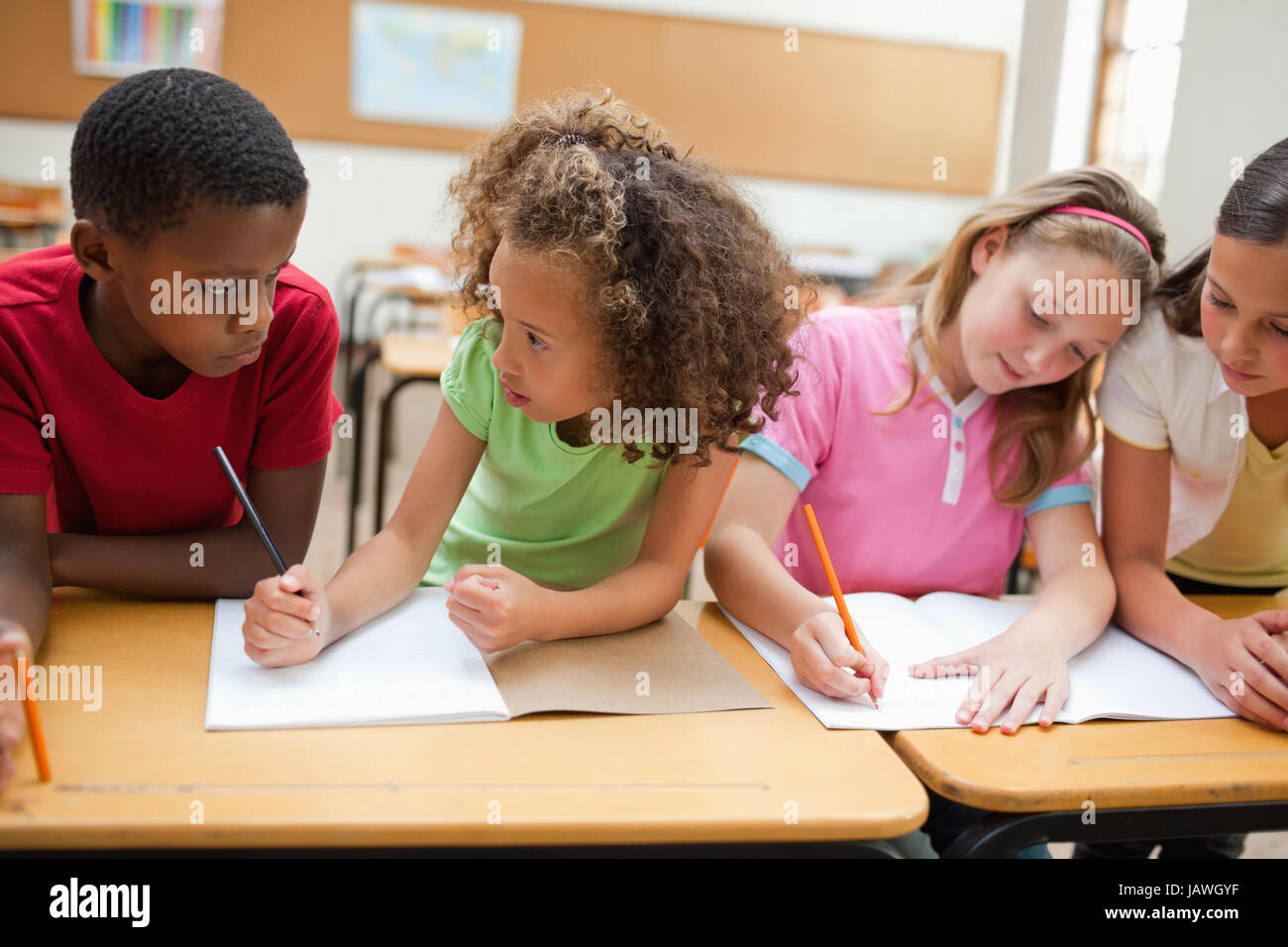 Students doing teamwork in class Stock Photo - Alamy