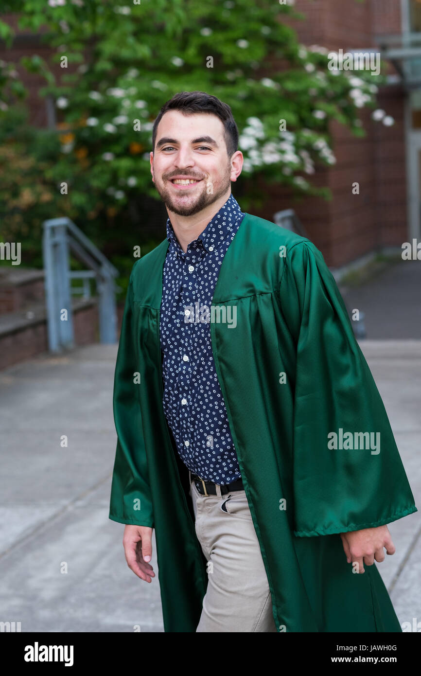 Male model wearing a graduation gown on campus at a university in Oregon Stock Photo Alamy