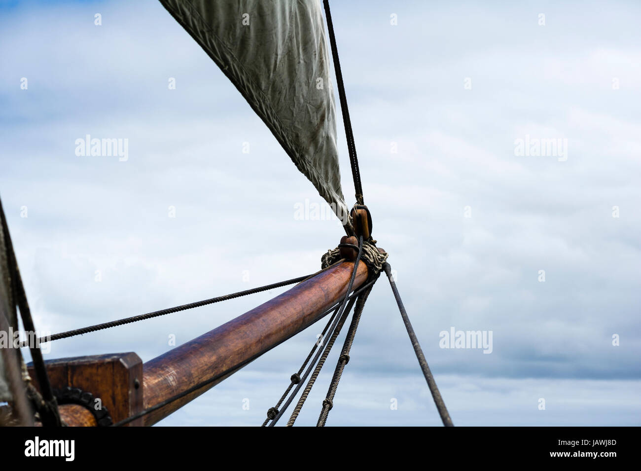 Canvas sail ropes and bow sprit on an antique timber sailing ship. Stock Photo