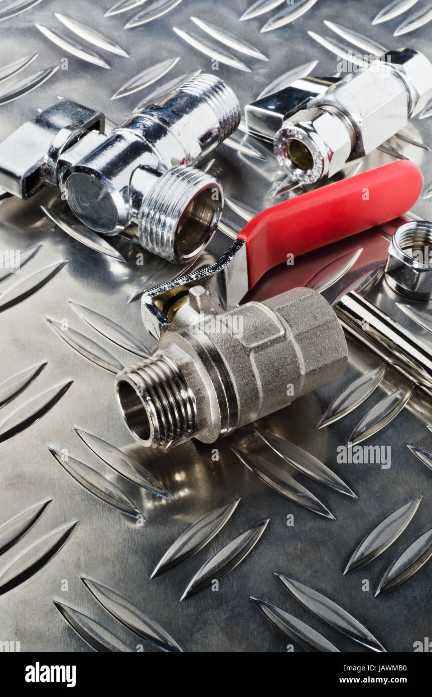 Plumbing inlet pipe valve on a metal surface Stock Photo - Alamy