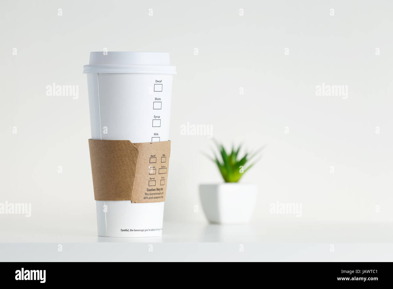 White Paper Cup and green potted plant Stock Photo - Alamy