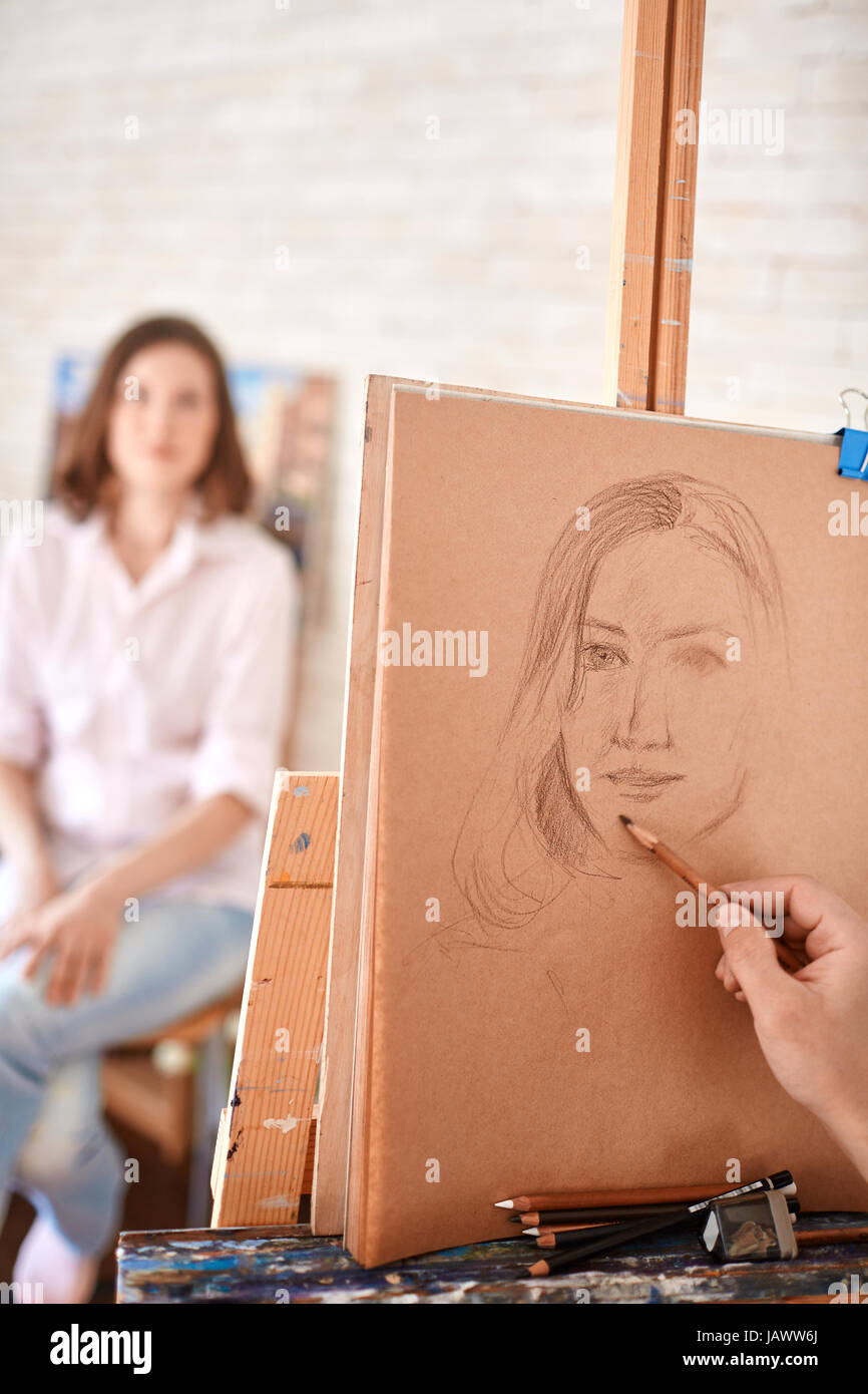 Artist Drawing Sketch of Portrait in Studio Stock Photo