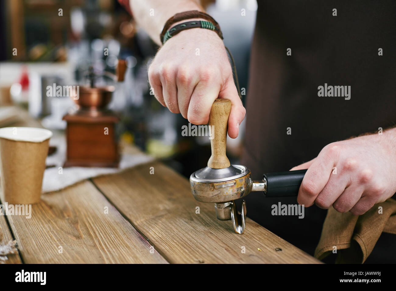 Masterful Barista Pressing Coffee Grains with Tamper Stock Photo