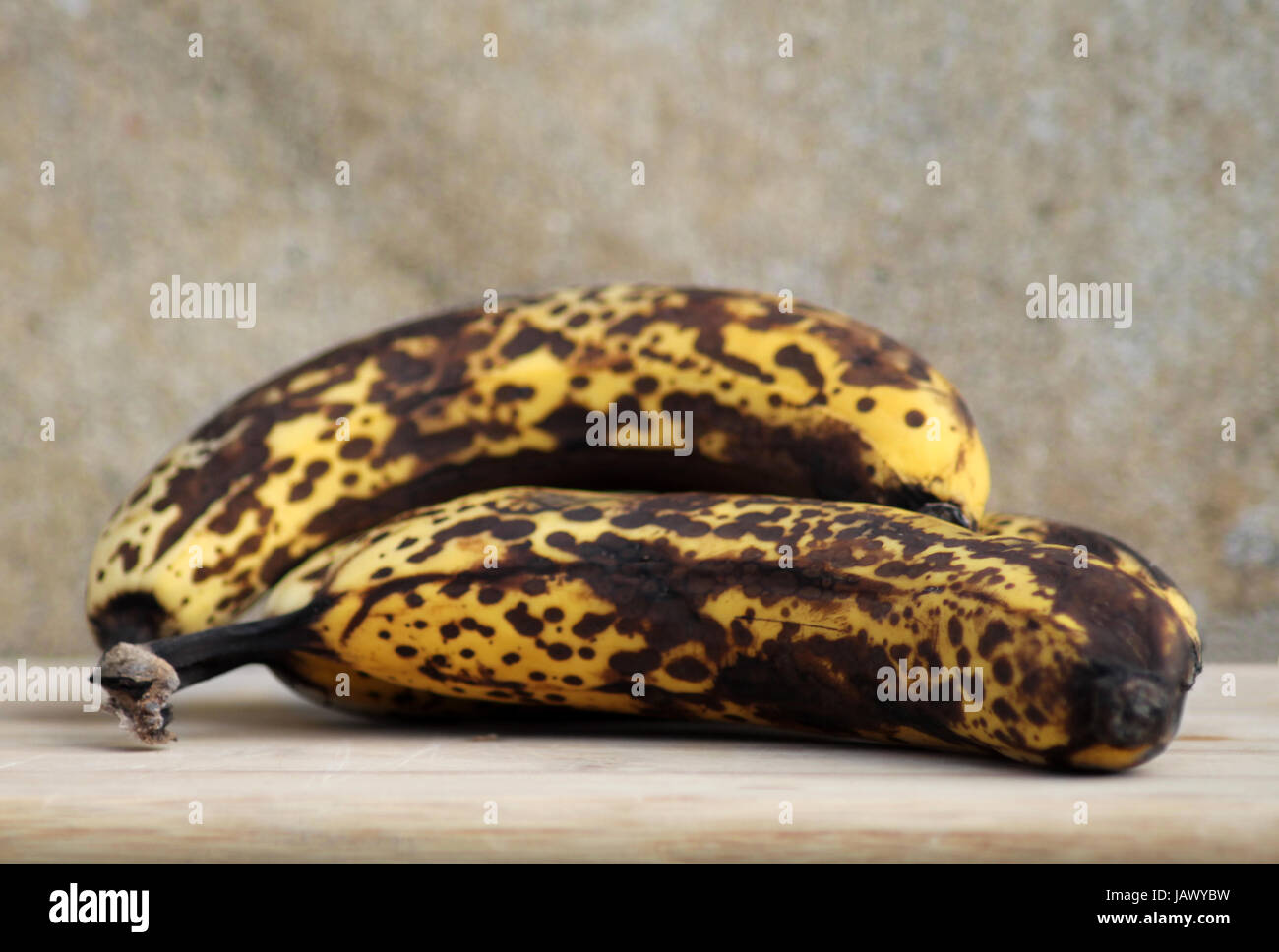 Bunch of very ripe bananas on studio background. Stock Photo