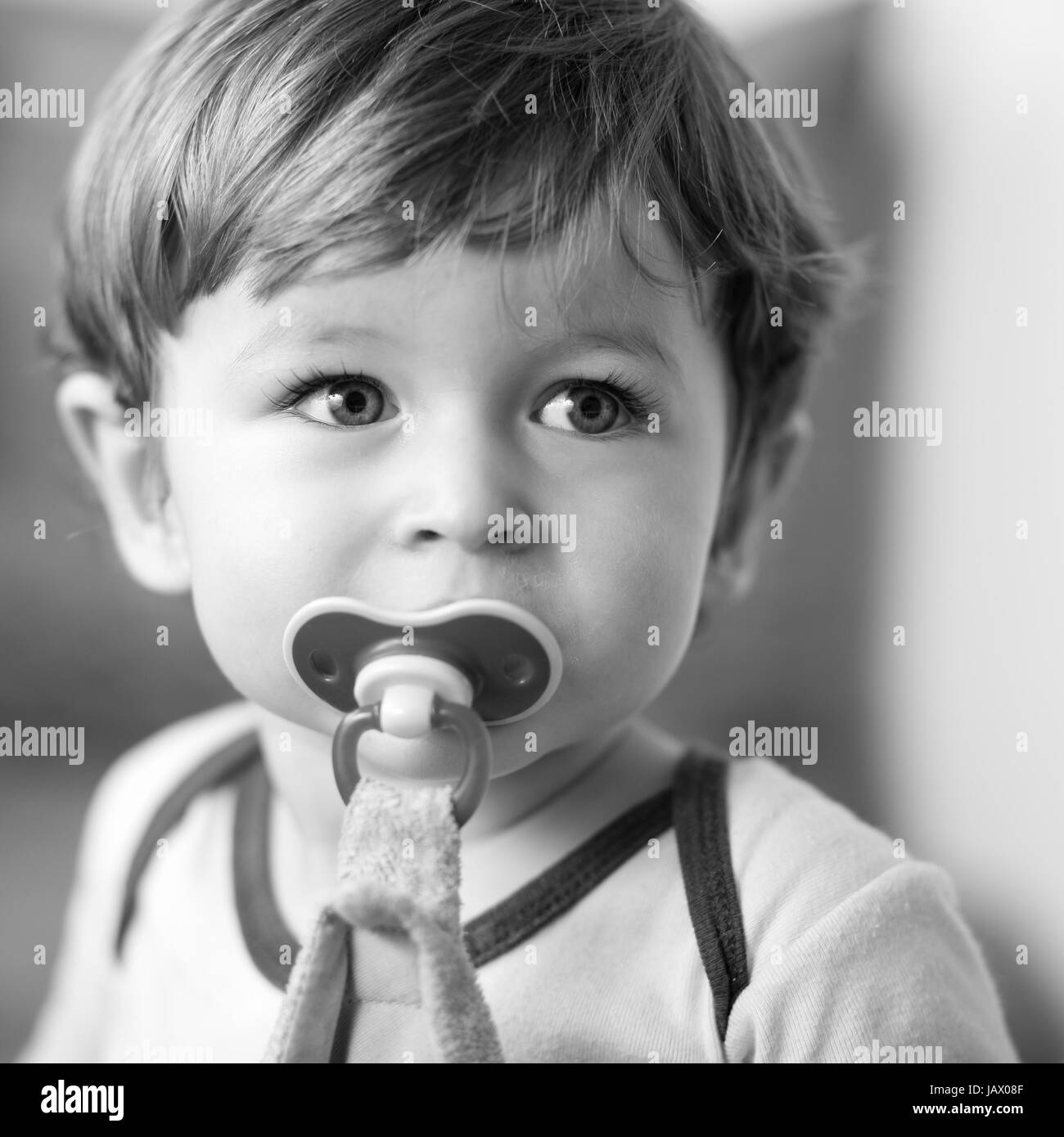 Details of a portrait of a caucasian boy with his pacifier Stock Photo