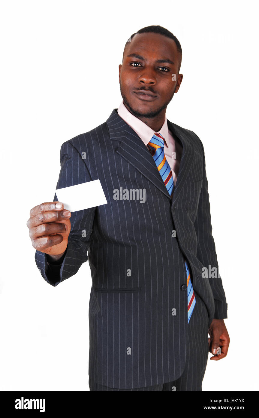 A young black business man standing in a suit and tie, holding up a ...