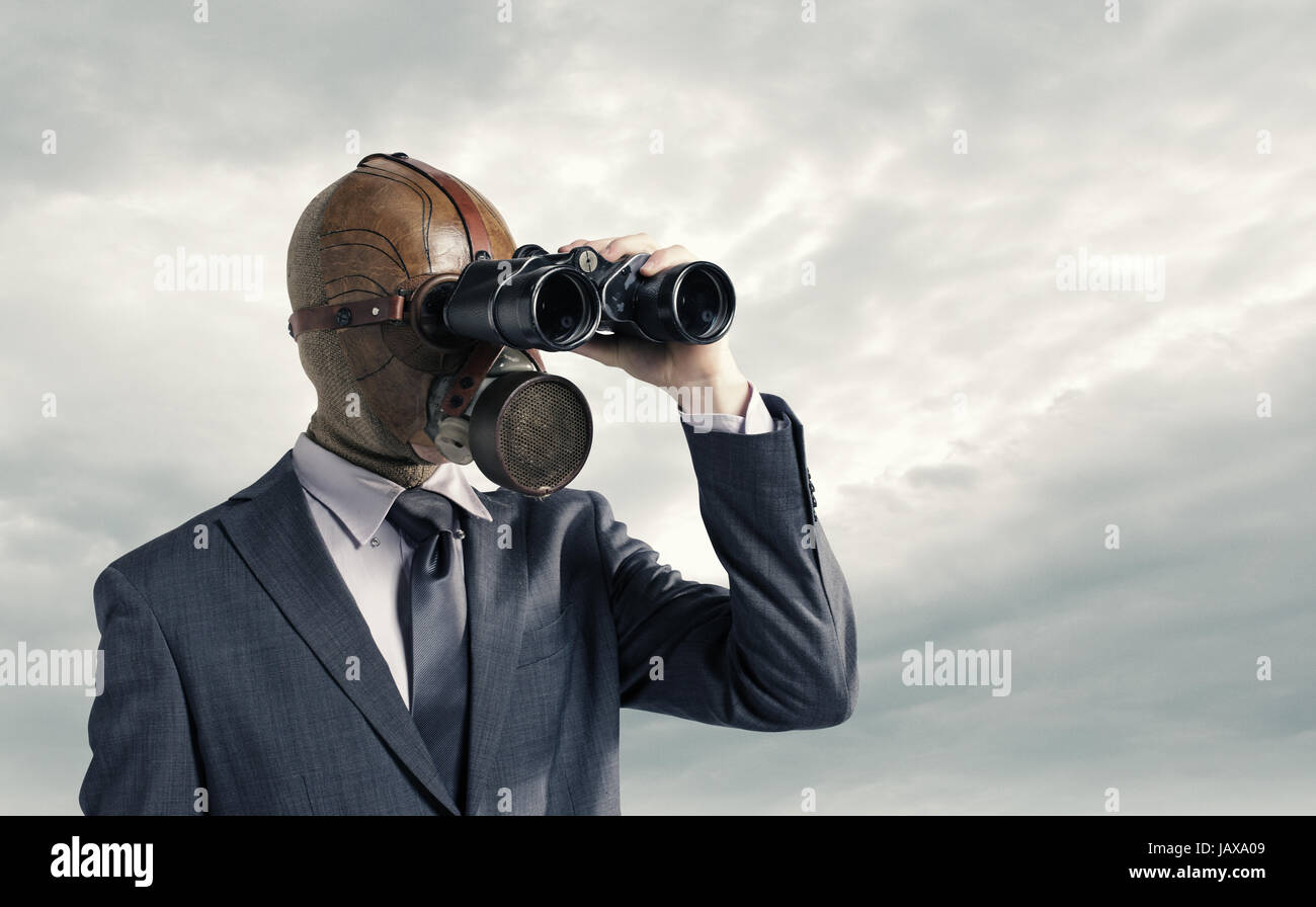 Businessman with gas mask  looking through binoculars Stock Photo