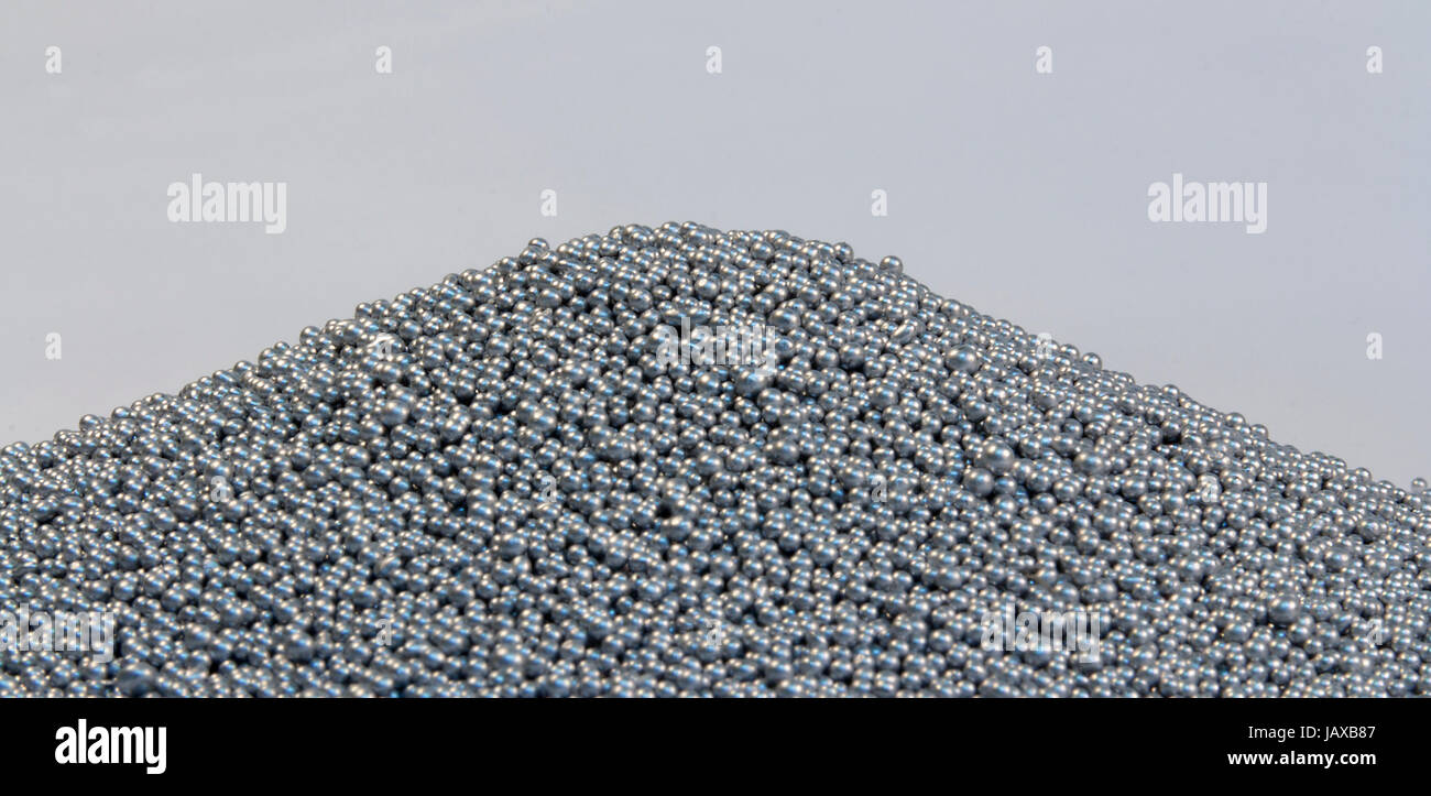 pile of silver metallic beadlets in light grey back Stock Photo