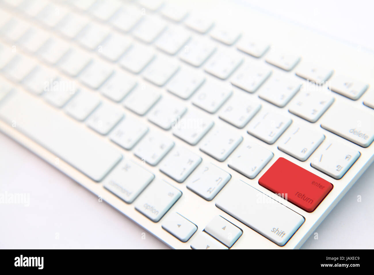 perspective of red return button on white modern keyboard Stock Photo