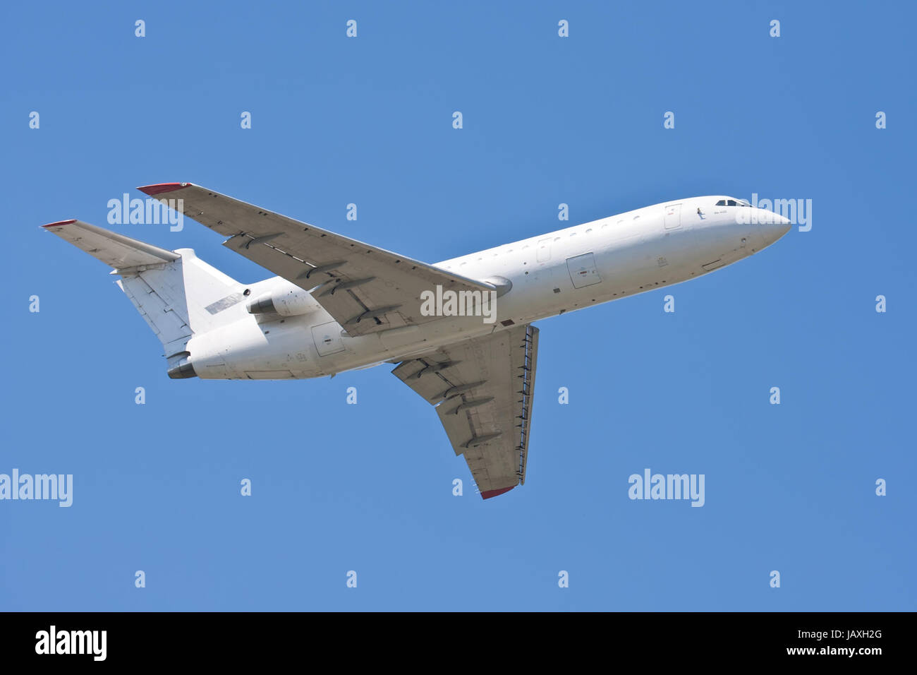 Beautiful white passenger airplane in blue sky Stock Photo - Alamy