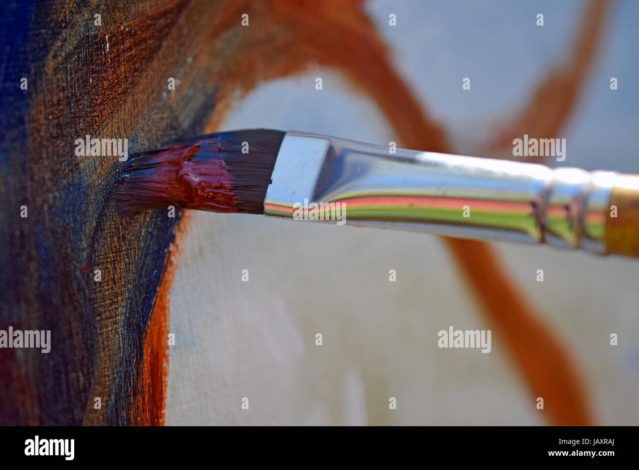 Close up of paint brush on canvas when artist painting with oil colors. Stock Photo