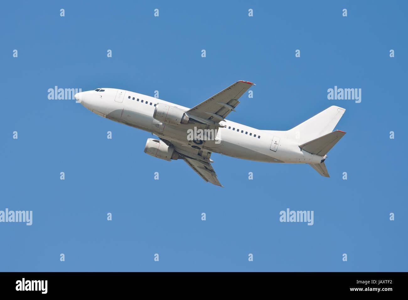 Beautiful white passenger airplane in blue sky Stock Photo - Alamy