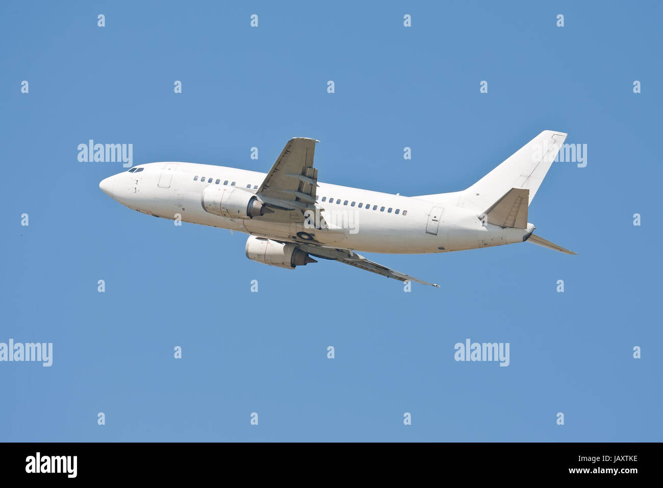 Beautiful white passenger airplane in blue sky Stock Photo - Alamy