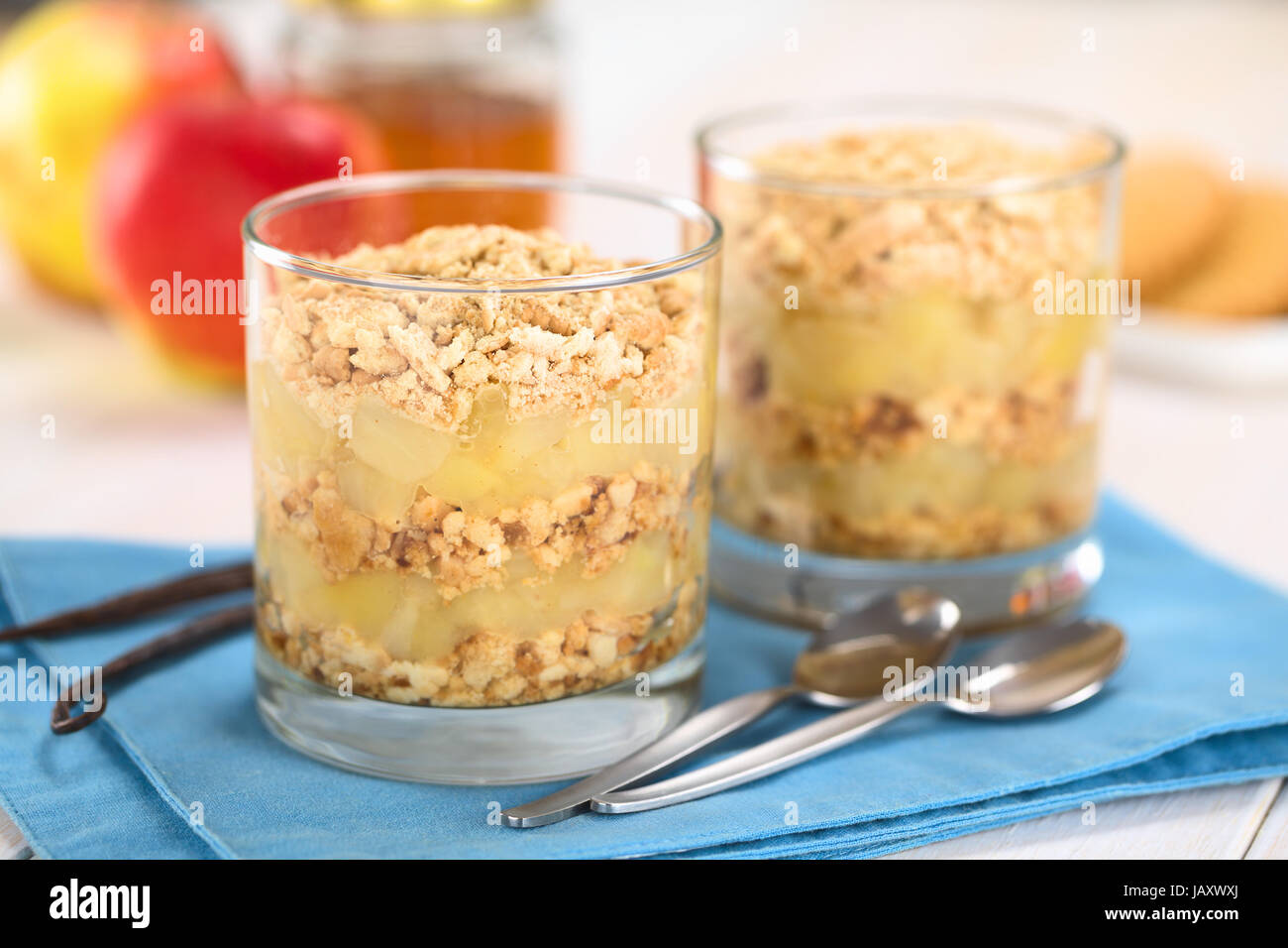 Simple no-bake Danish apple cake called Aeblekage made of stewed apple and vanilla cookie crumbs served in glass (Selective Focus, Focus on the front of the upper two layers) Stock Photo