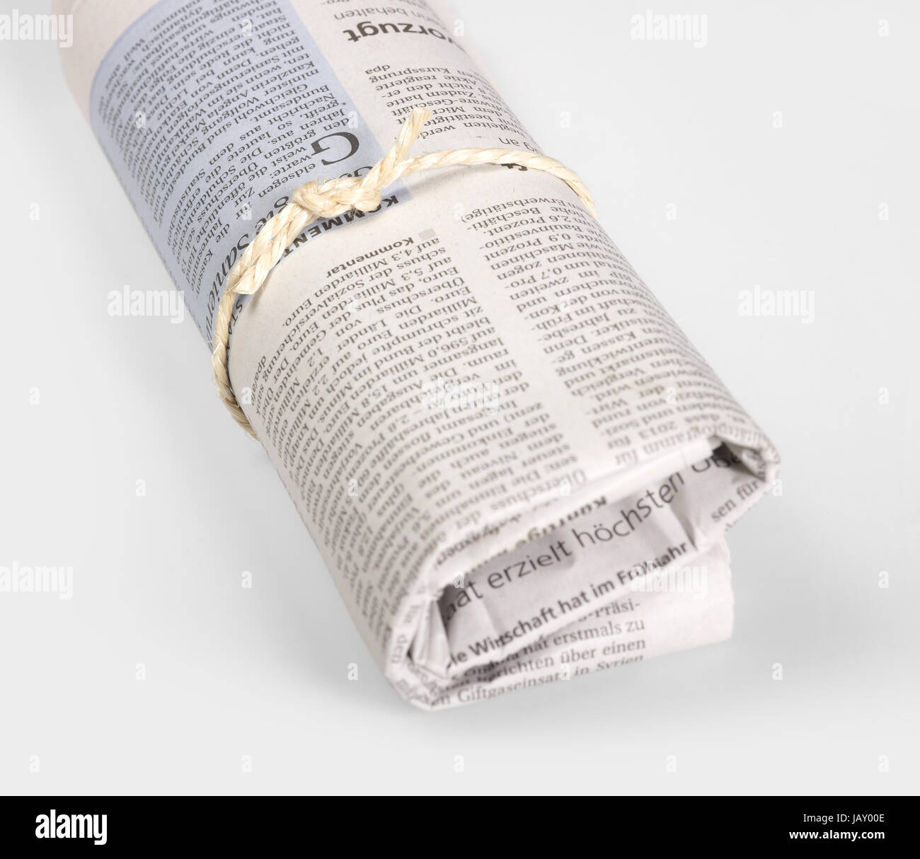 rolled german newspaper in light back Stock Photo