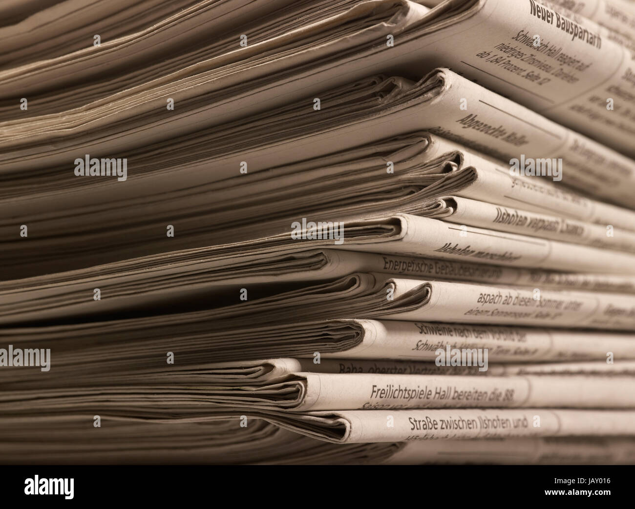full frame background with lots of stacked newspapers Stock Photo