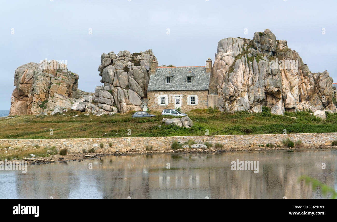 traditional breton house between some rocks at the Pink Granite Coast