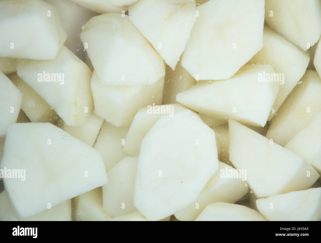 Raw potatoes in water ready to cook Stock Photo Alamy